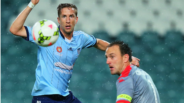 Adelaide goalkeeper Eugene Galekovic makes a save against Sydney FC striker Marc Janko.