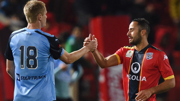 Matt Simon shakes hands with Adelaide United defender Tarek Elrich.