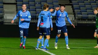 Macallister celebrates a goal with team mates
