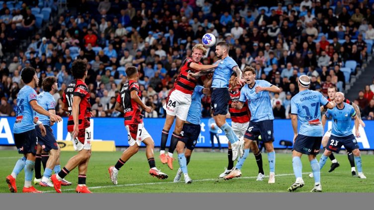 Nathan Barrie of the Wanderers competes with Alexandar Popovic of Sydney FC at Allianz Stadium.