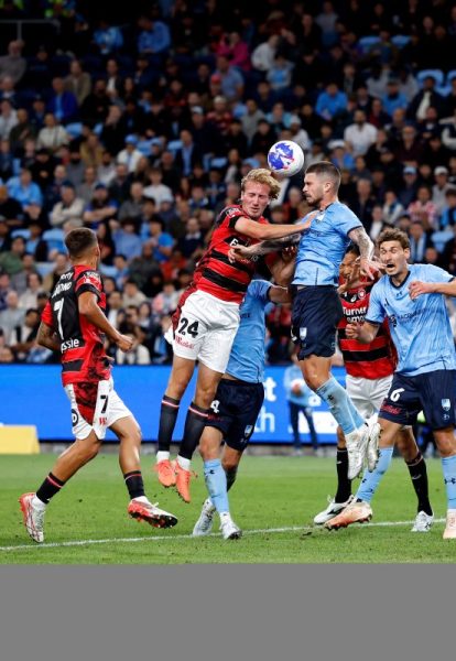 Nathan Barrie of the Wanderers competes with Alexandar Popovic of Sydney FC at Allianz Stadium.