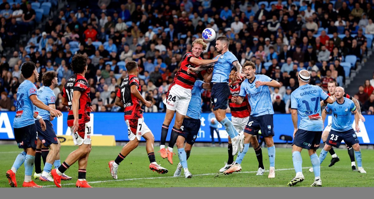 Nathan Barrie of the Wanderers competes with Alexandar Popovic of Sydney FC at Allianz Stadium.