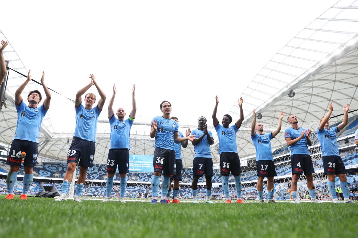 Sydney FC players celebrate victory after the match at Allianz Stadium.